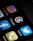 a close up of a cell phone with different social icons
