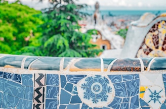 A beautifully crafted mosaic table set in a sunlit garden.