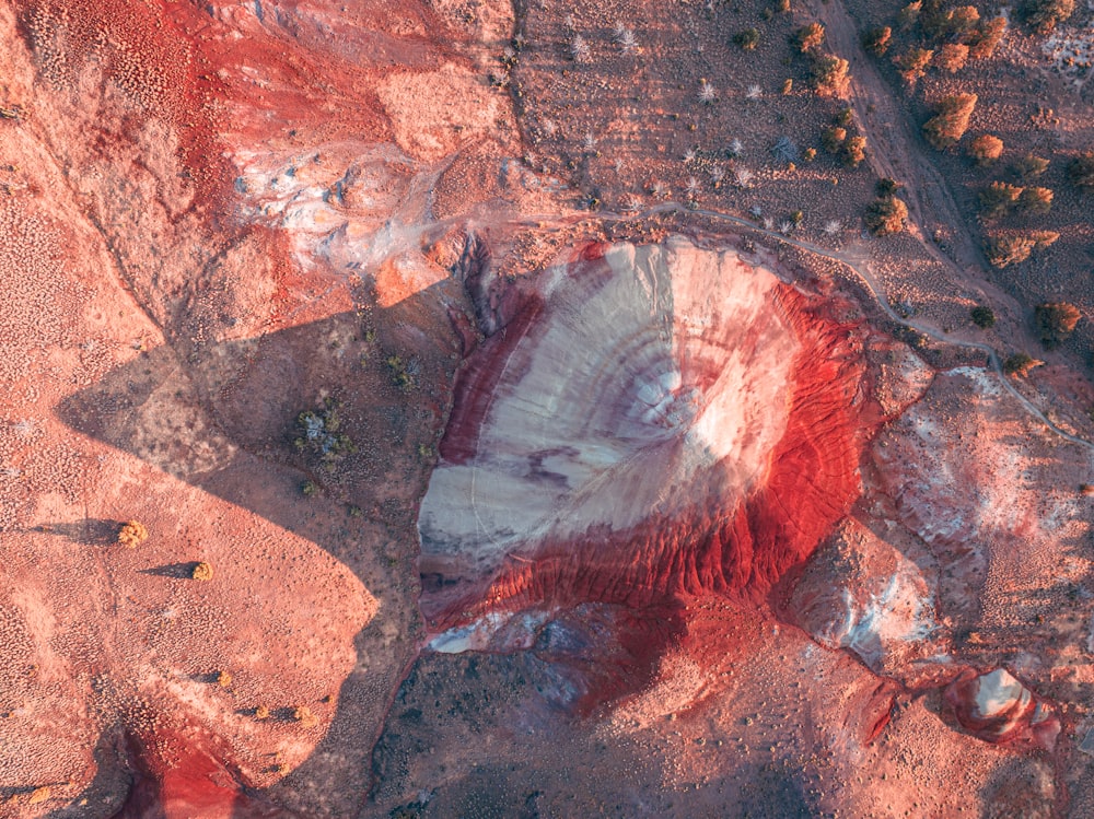 an aerial view of a red and white mountain