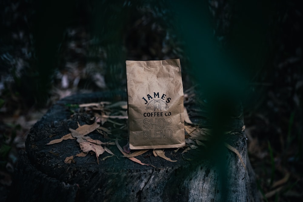 a bag of coffee sitting on top of a tree stump