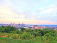 A panoramic view of the Philadelphia skyline at sunset, with banners for the CDC-USA National Convention 2026 fluttering in the foreground.