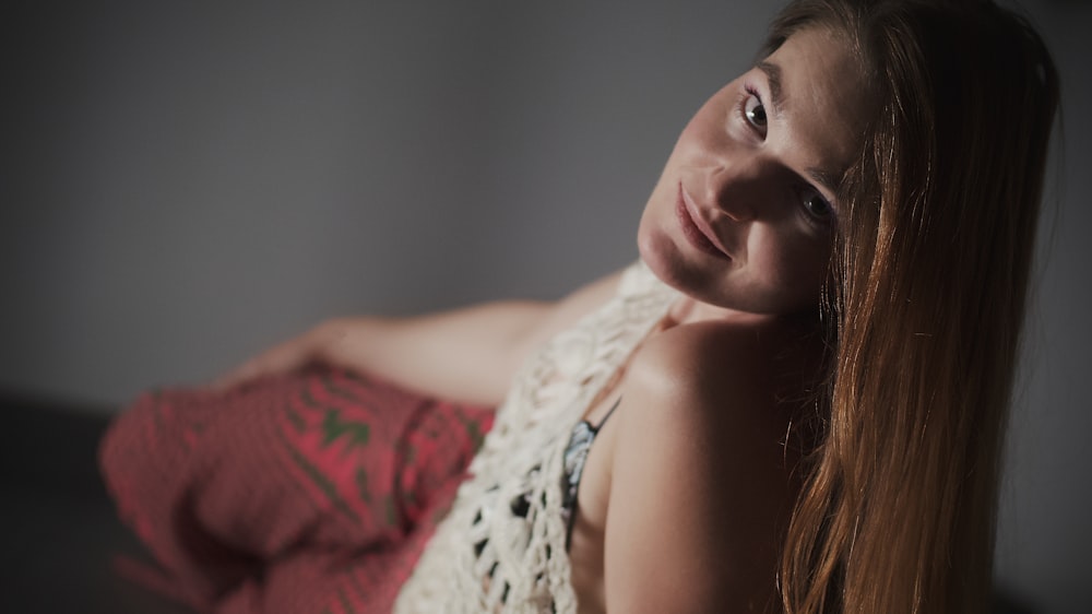 a woman with long red hair posing for a picture