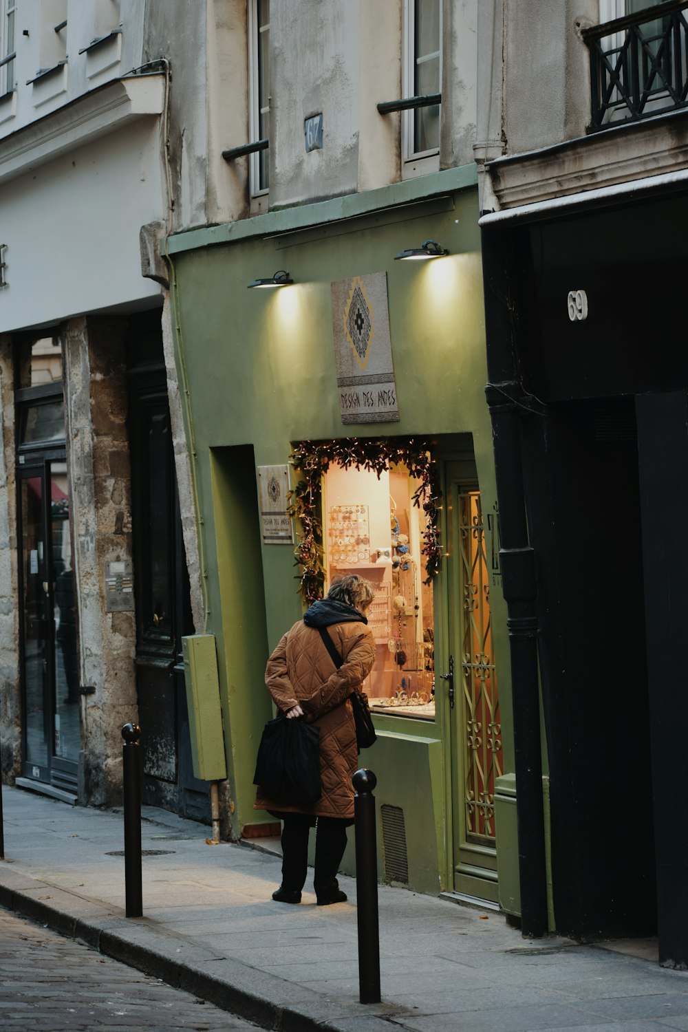 a woman is standing outside of a store