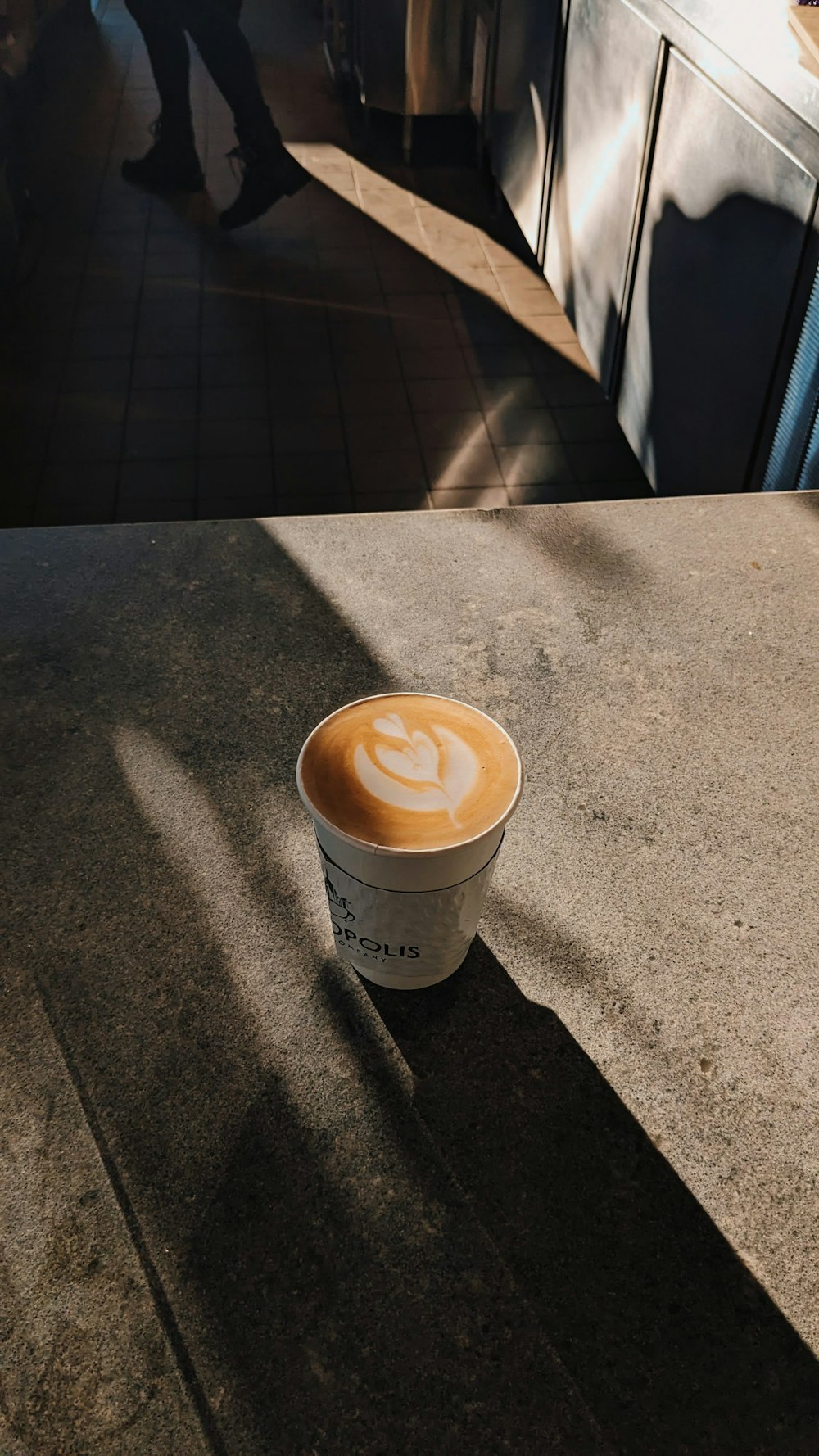 a cup of coffee sitting on top of a counter