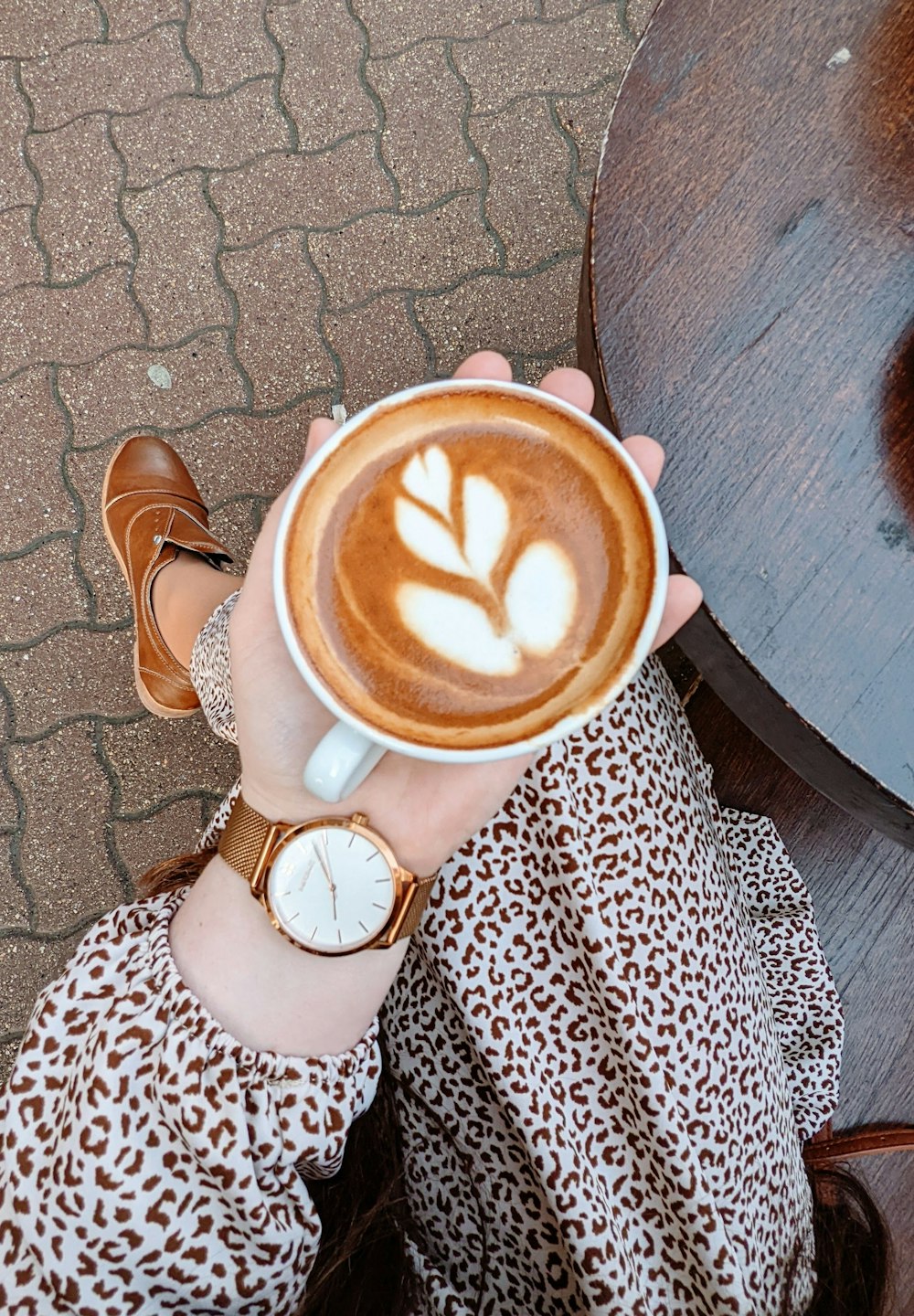 a woman is holding a cup of coffee