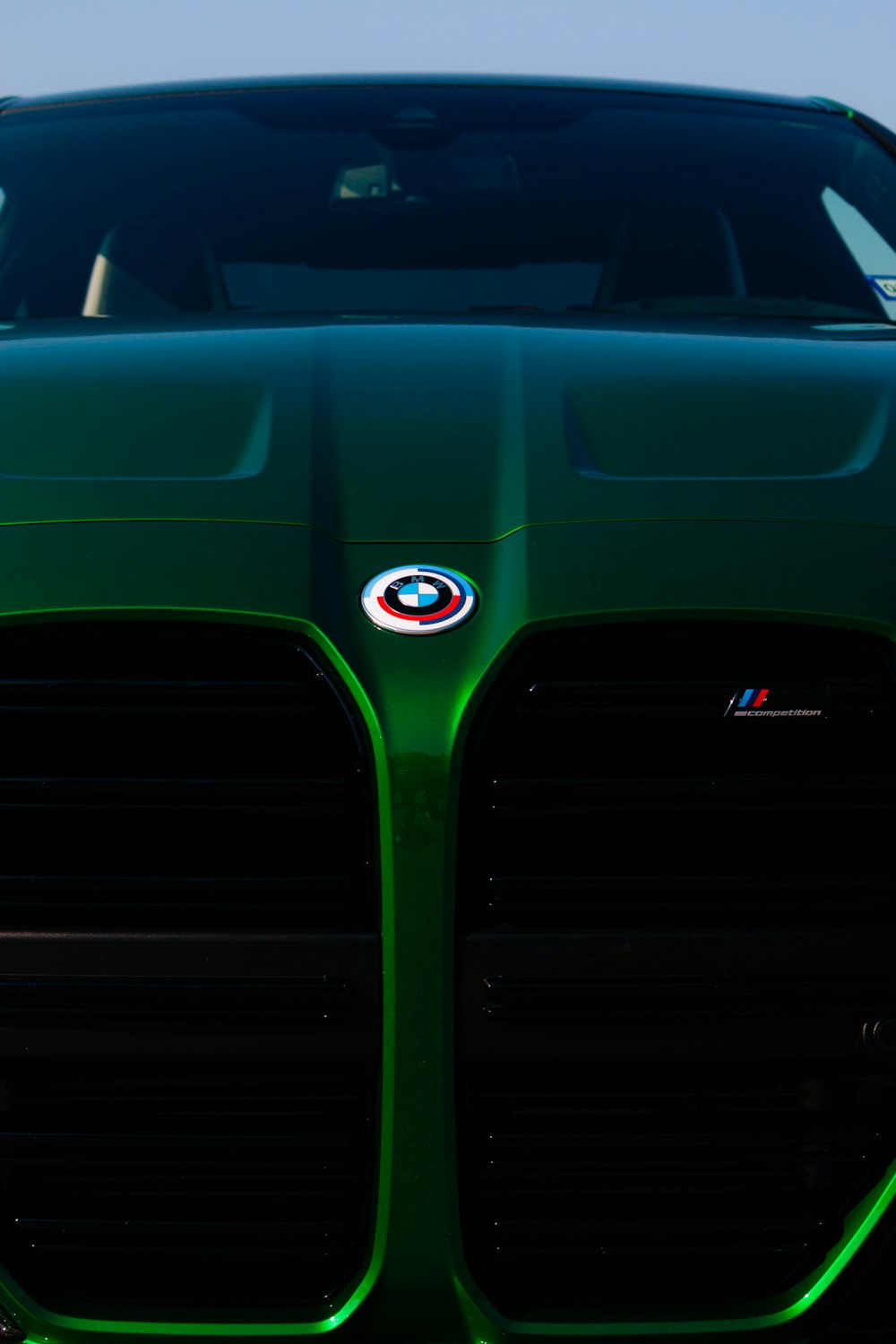 a close up of the front of a green sports car