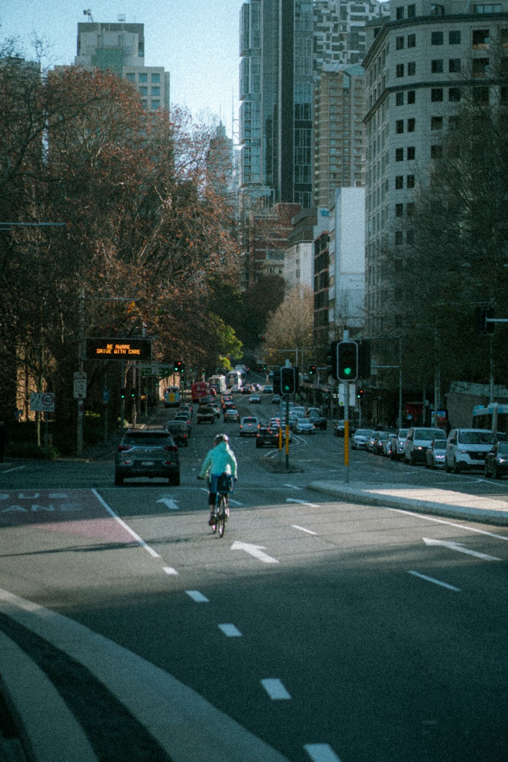 a person riding a bike on a city street