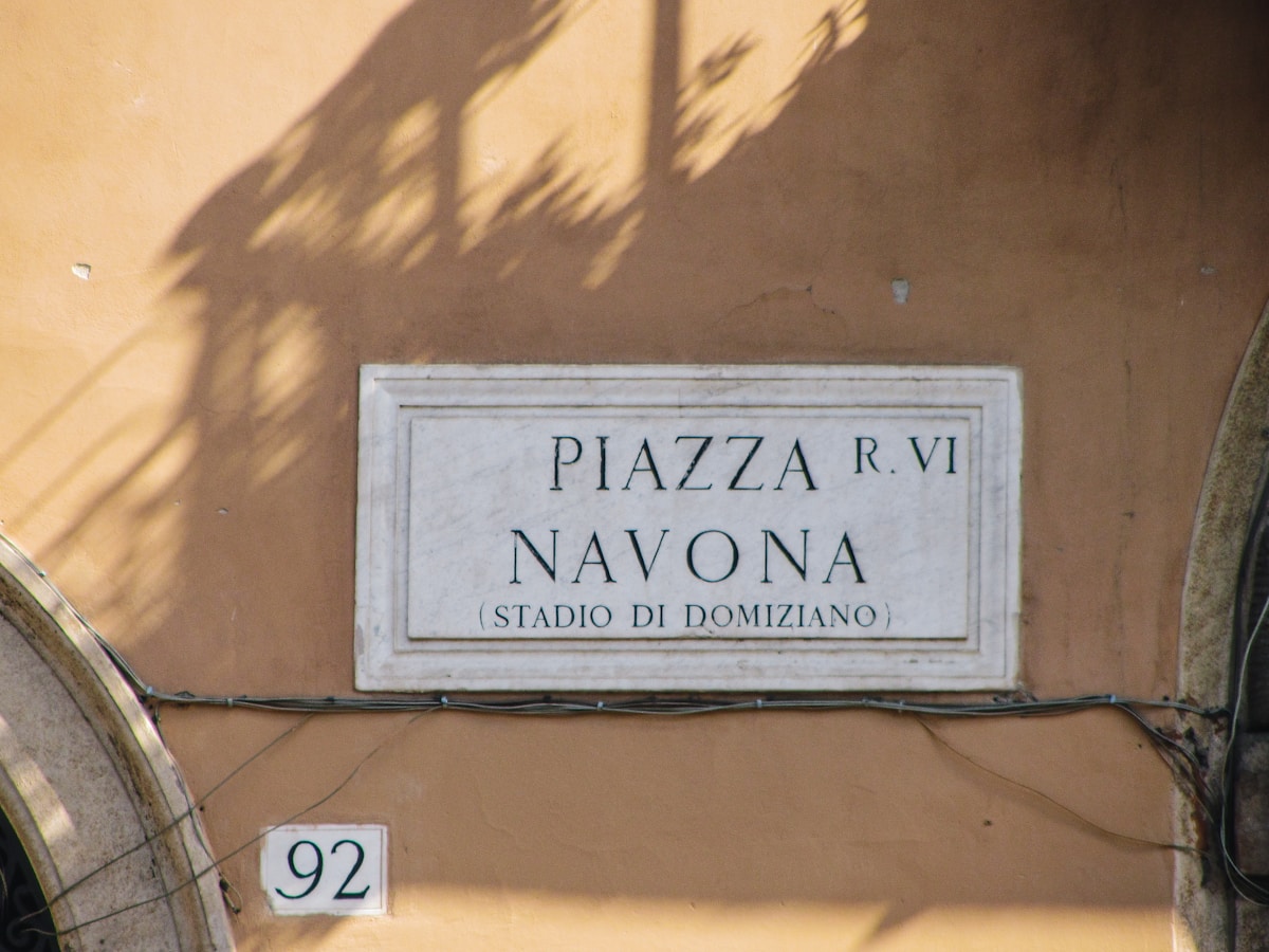 Piazza Navona in Rome's historic centre with Baroque fountains and street artists at dusk