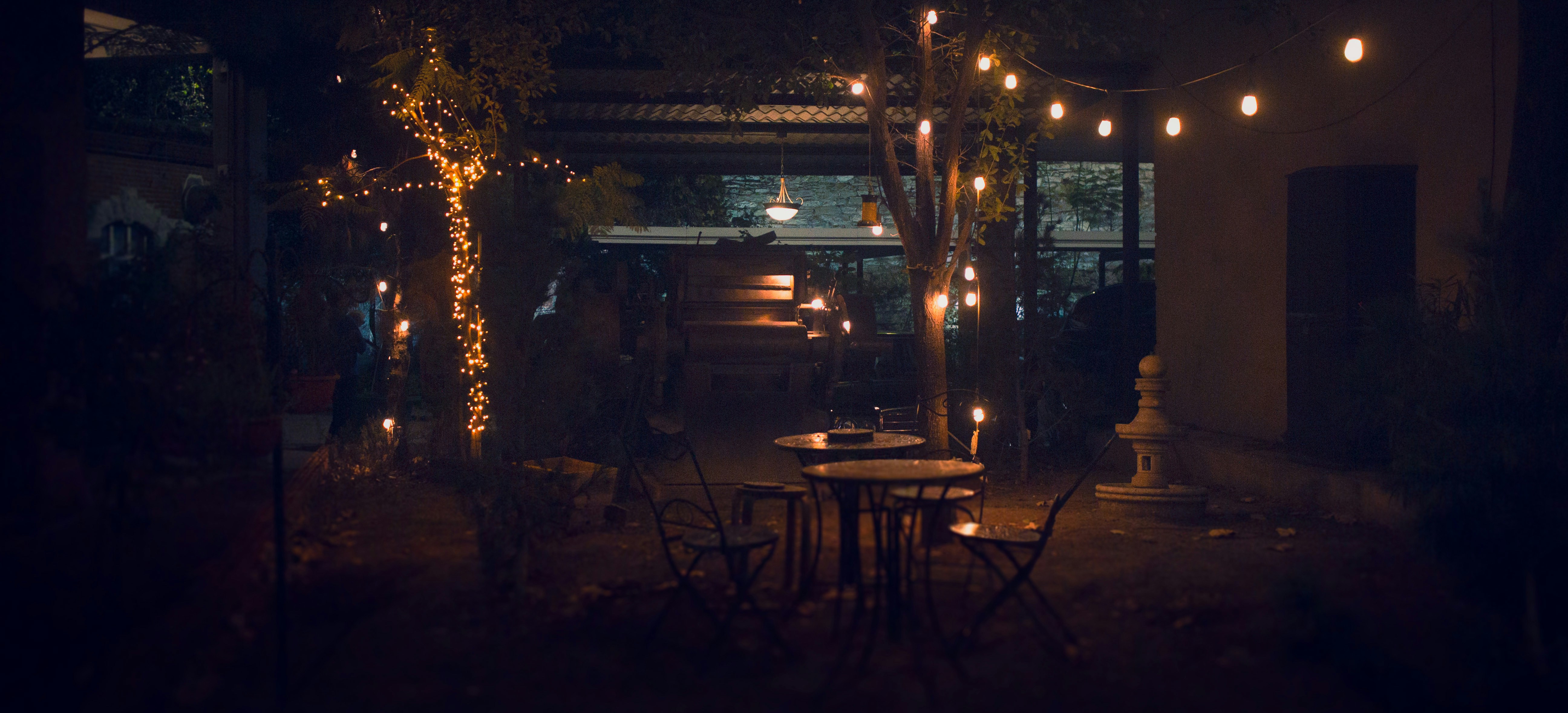 a table and chairs are lit up at night