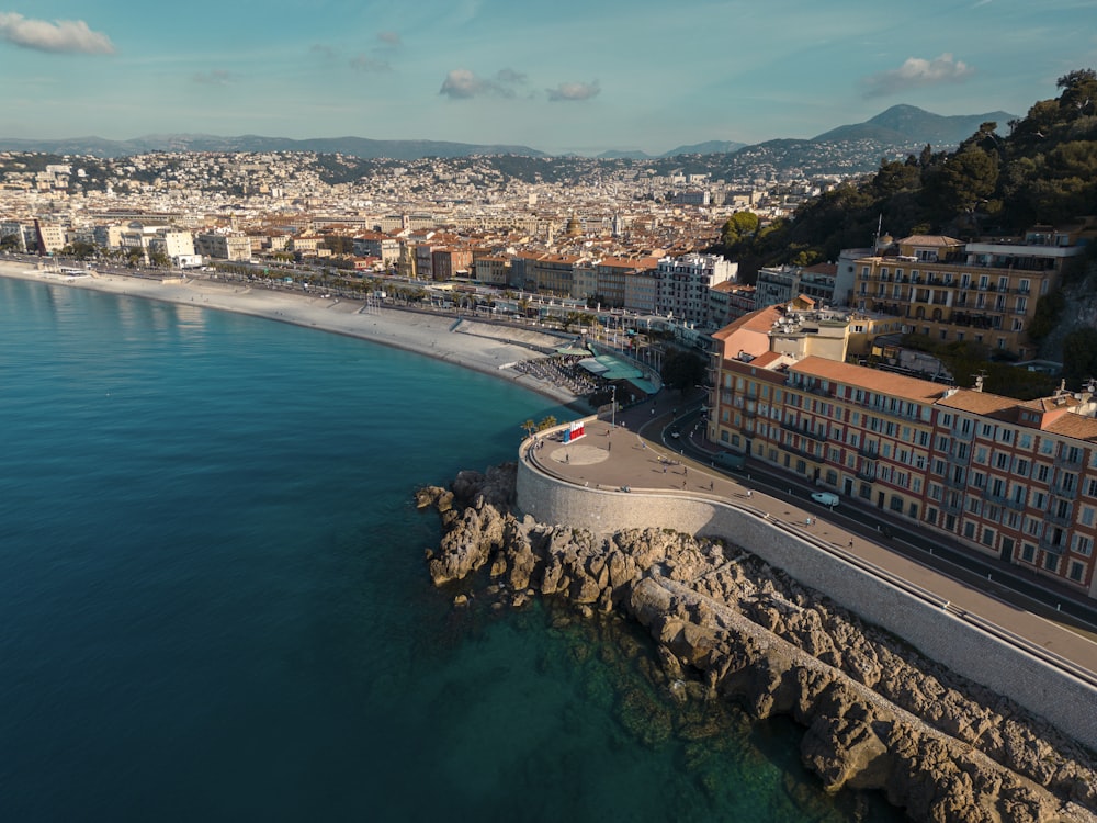 an aerial view of a city next to the ocean