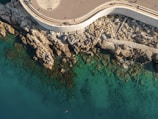Aerial shot of a winding coastal path leading to Eagle’s Billabong.