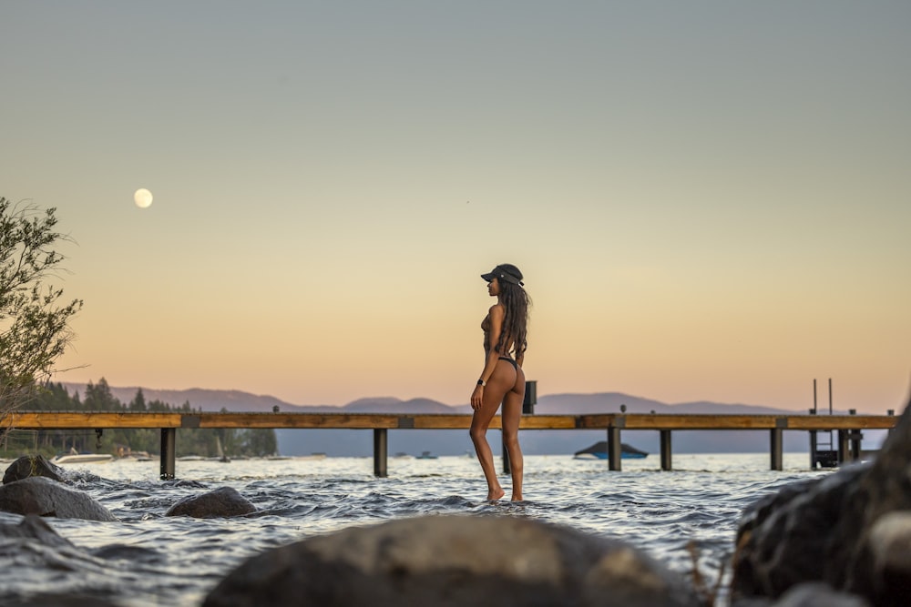 a woman in a bikini standing in the water