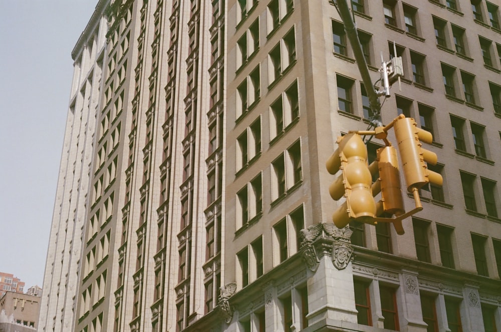 a traffic light hanging from the side of a tall building