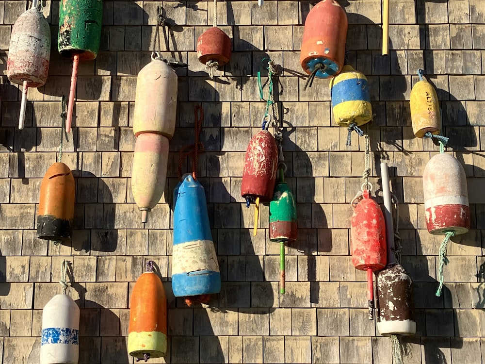 a bunch of buoys hanging on a brick wall