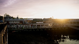 Cozy seafood restaurant interior with fishermen's nets and fresh catch displays at sunset.