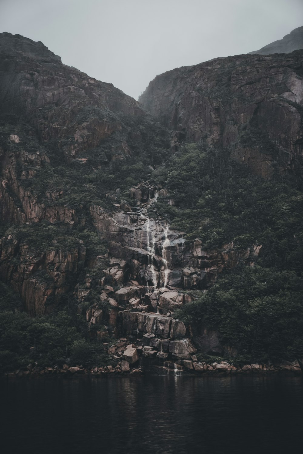 a waterfall in the middle of a body of water