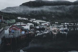 A serene coastal fishing village at dawn, with boats ready to set sail.
