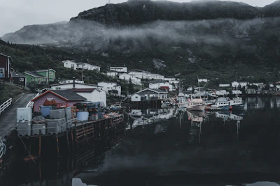 A serene coastal fishing village at dawn, with boats ready to set sail.