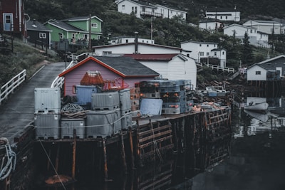 A rustic seaside village with fishing boats docked along the shore.