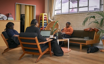 a group of people sitting around a living room