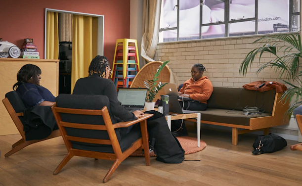 a group of people sitting around a living room