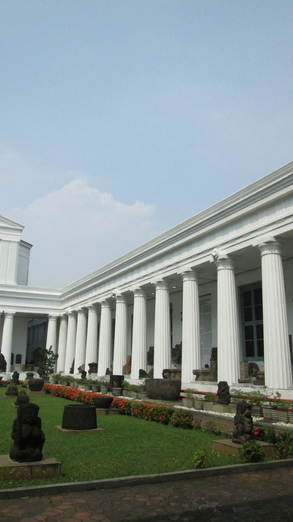 a building with columns and a lawn in front of it