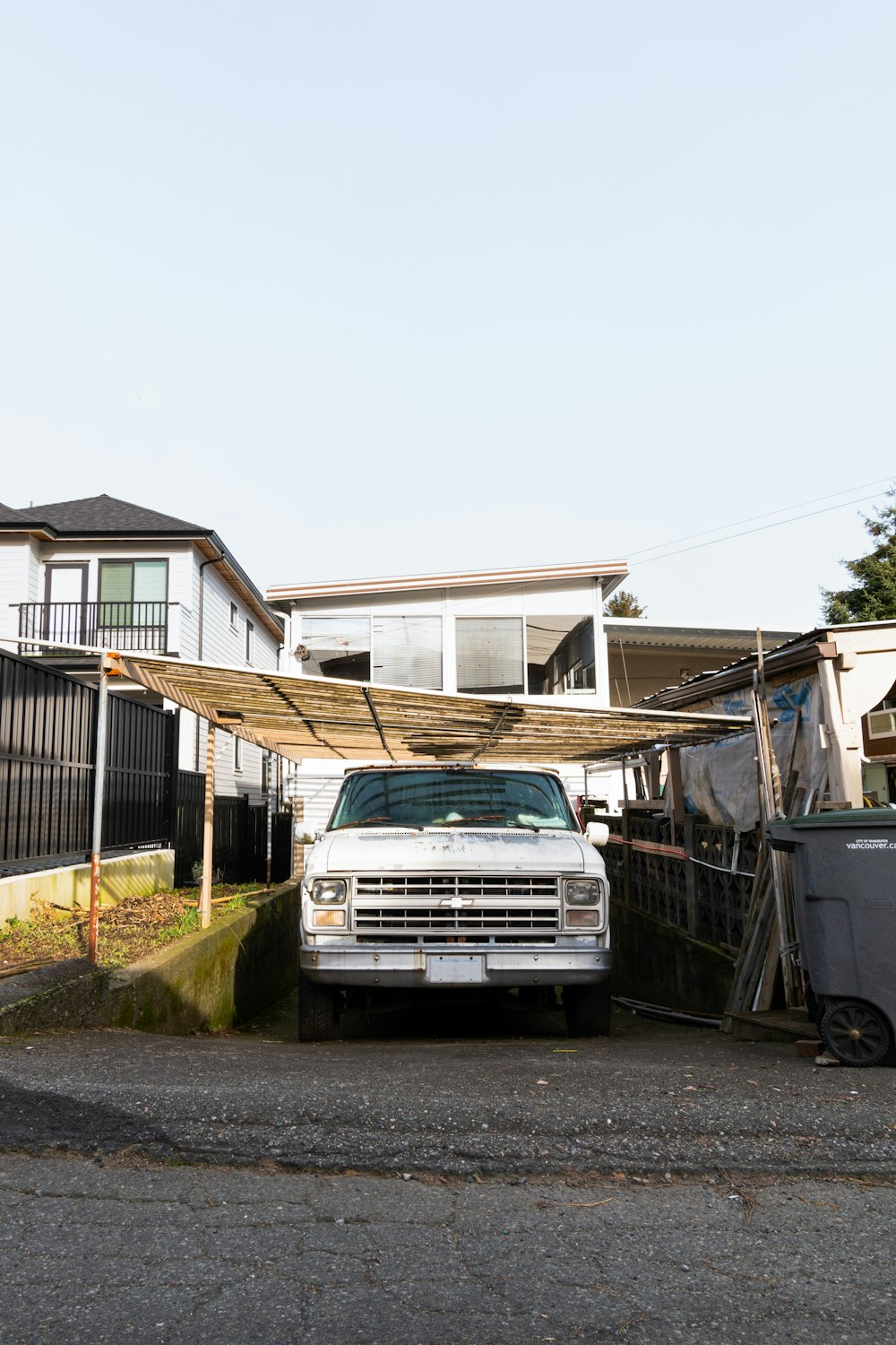 a white truck parked in front of a house