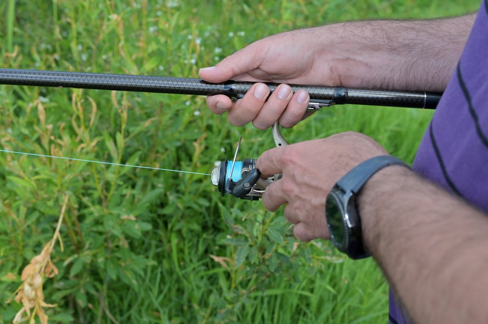 a man holding a fishing rod in his hands