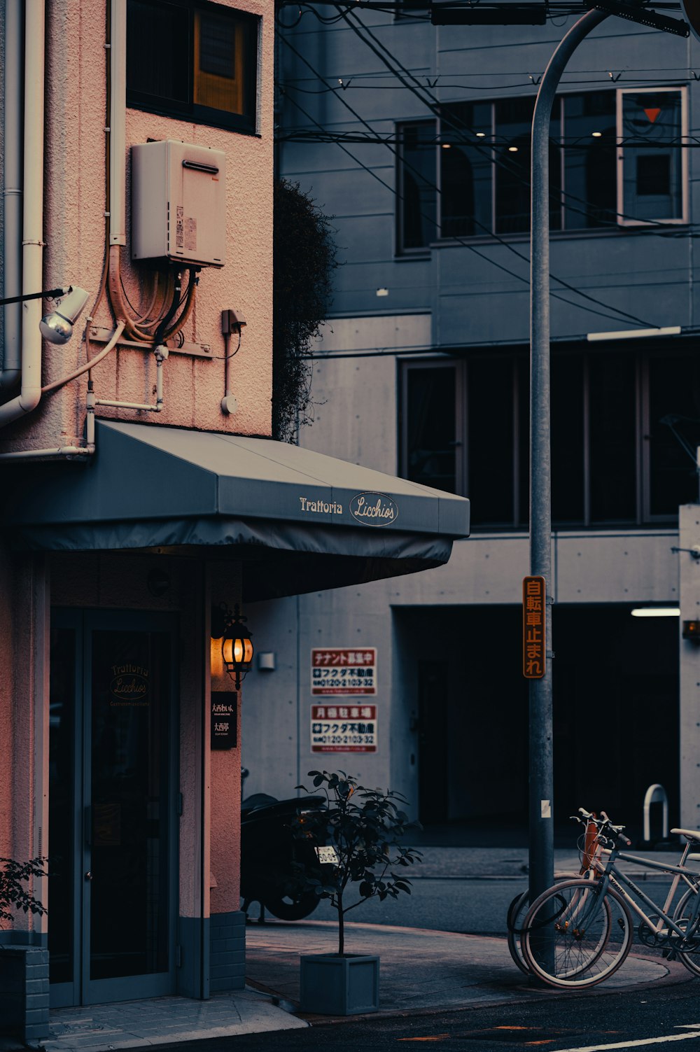 a couple of bikes are parked outside of a building