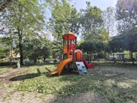 Children playing happily in a safe, colorful playground built by the organization.