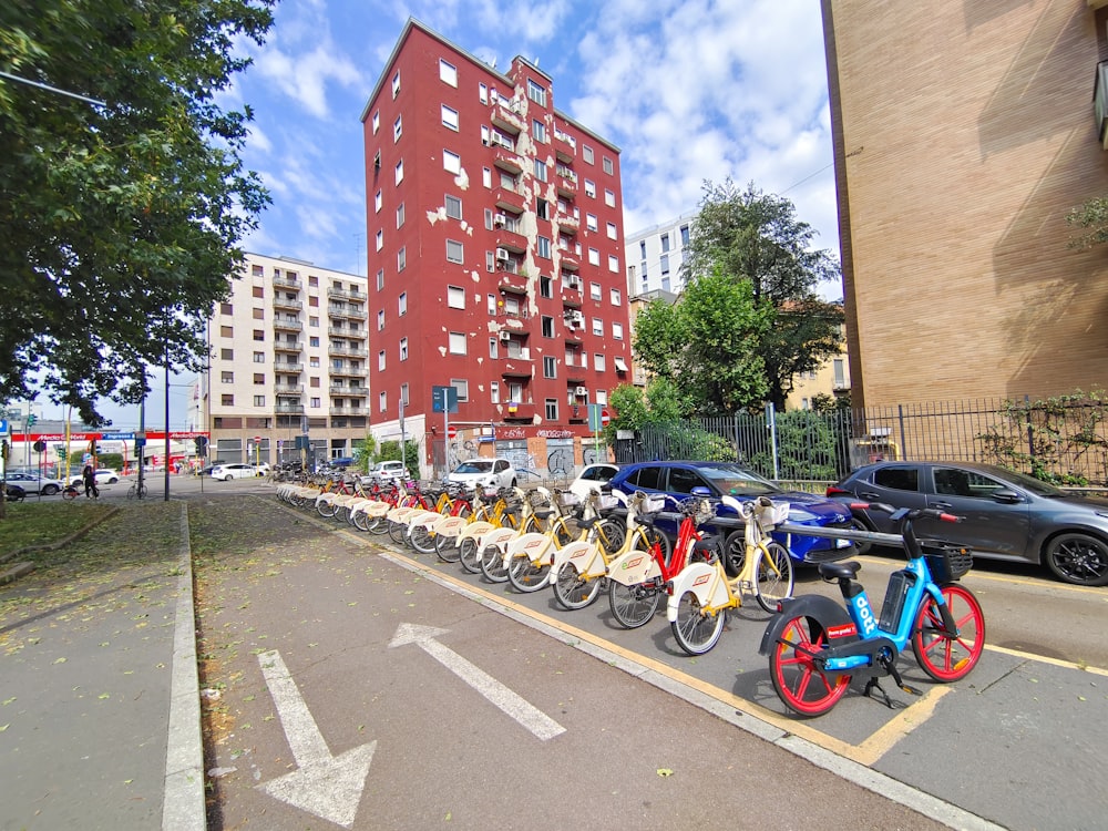 a row of bikes parked on the side of a road