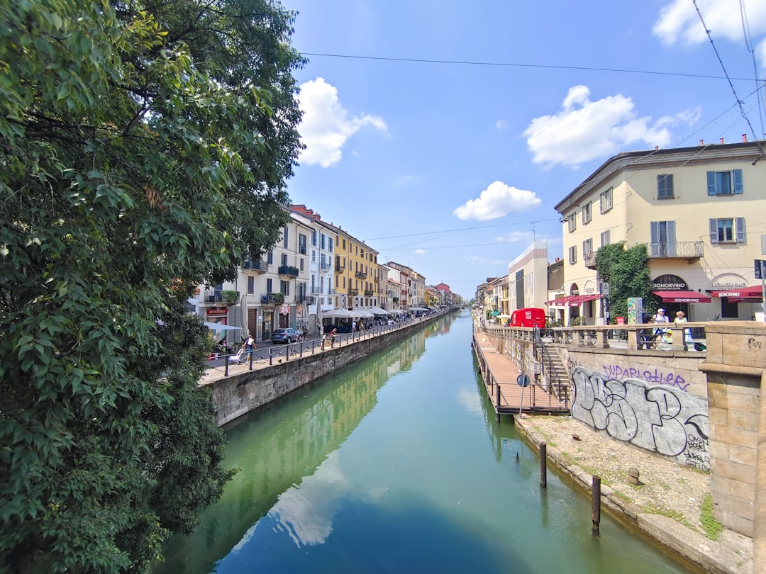 a river running through a city next to tall buildings,