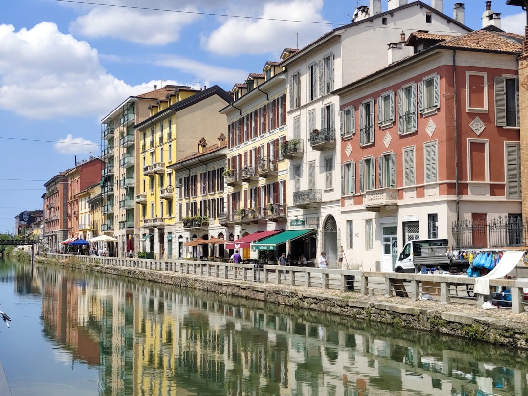 a river running through a city next to tall buildings,