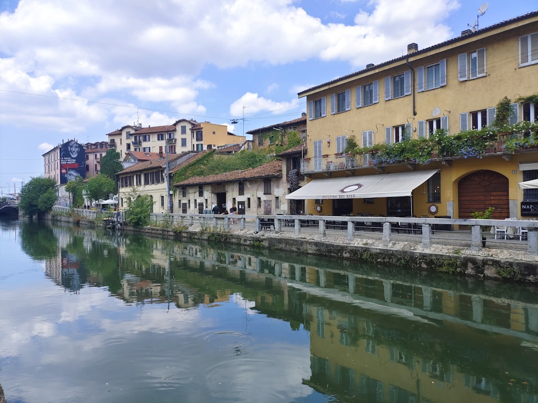 a river running through a city next to tall buildings,