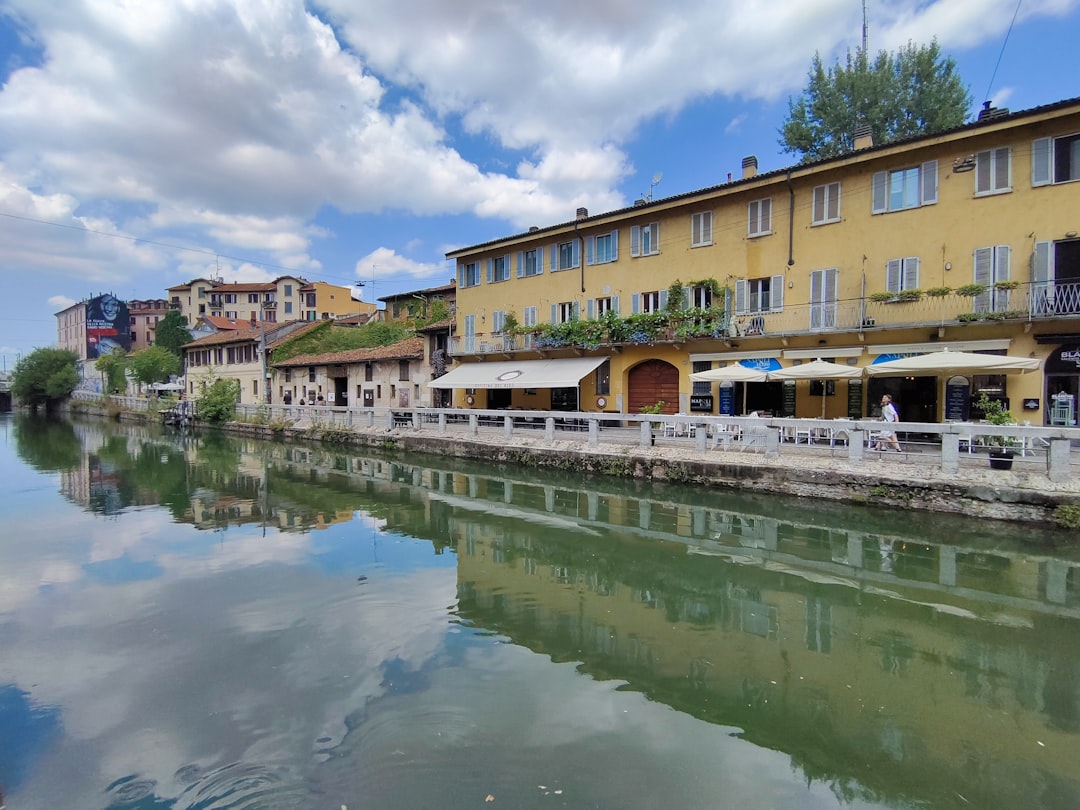 a river running through a city next to tall buildings,