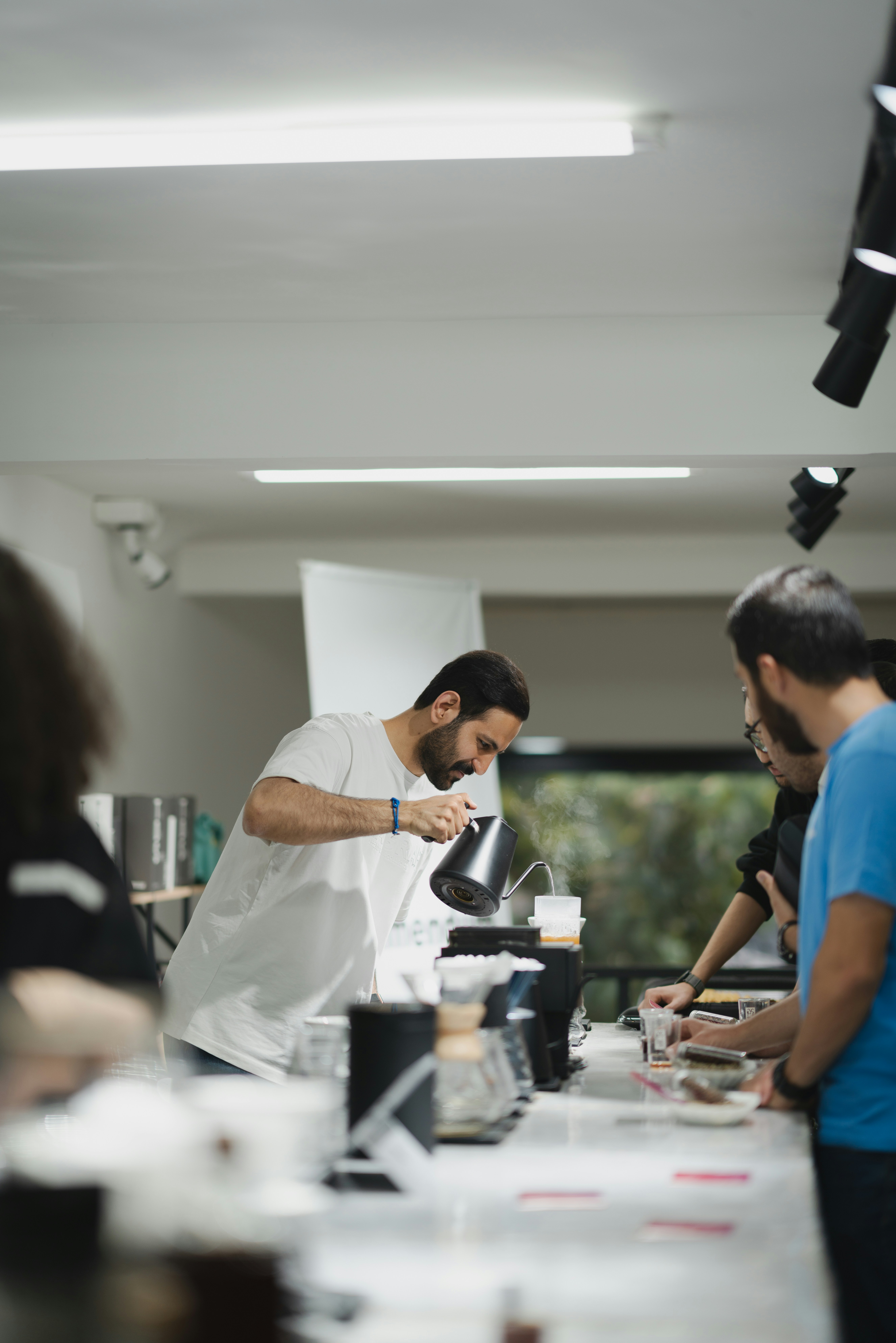 a group of people standing around a table