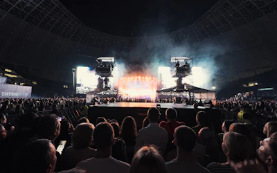 A community event stage bustling with activity, captured through multiple camera angles.