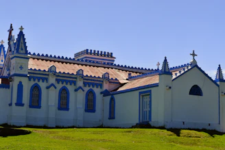 a white and blue building with a cross on top of it