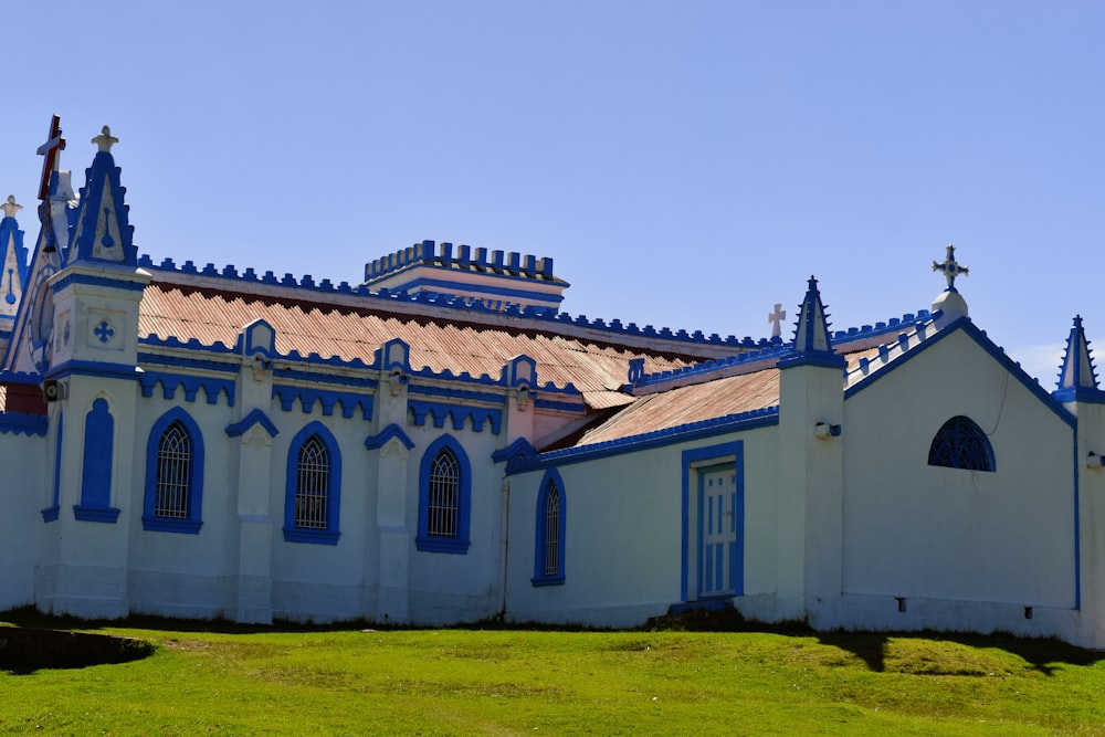 a white and blue building with a cross on top of it