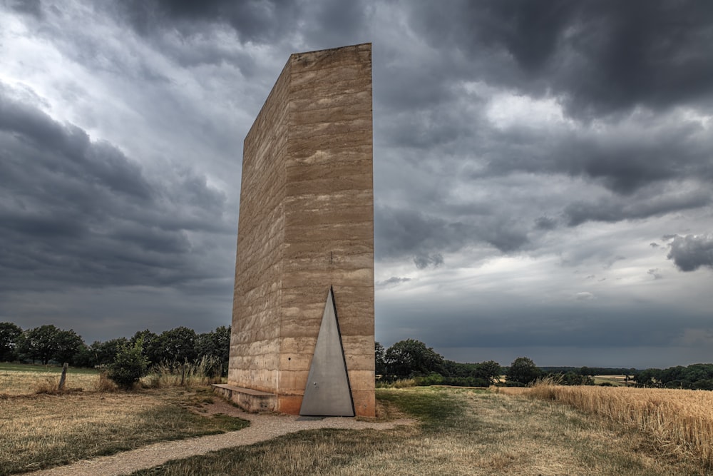 a tall stone monument sitting in the middle of a field