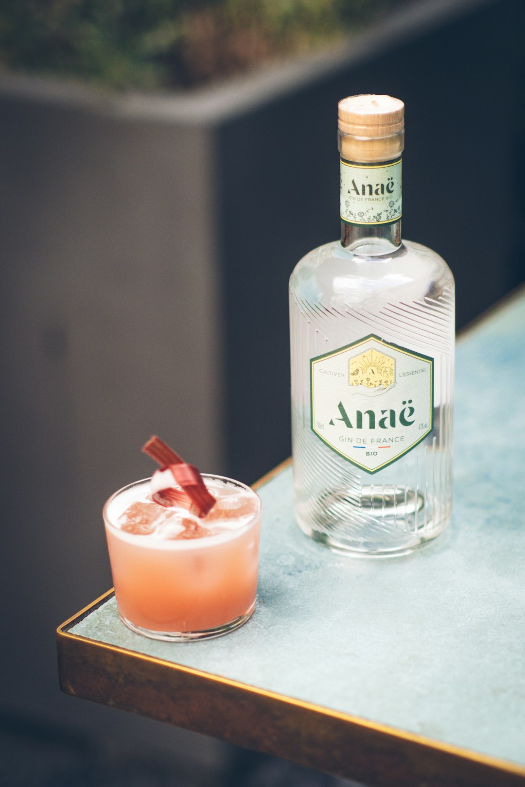 a bottle of alcohol sitting next to a glass with a drink in it