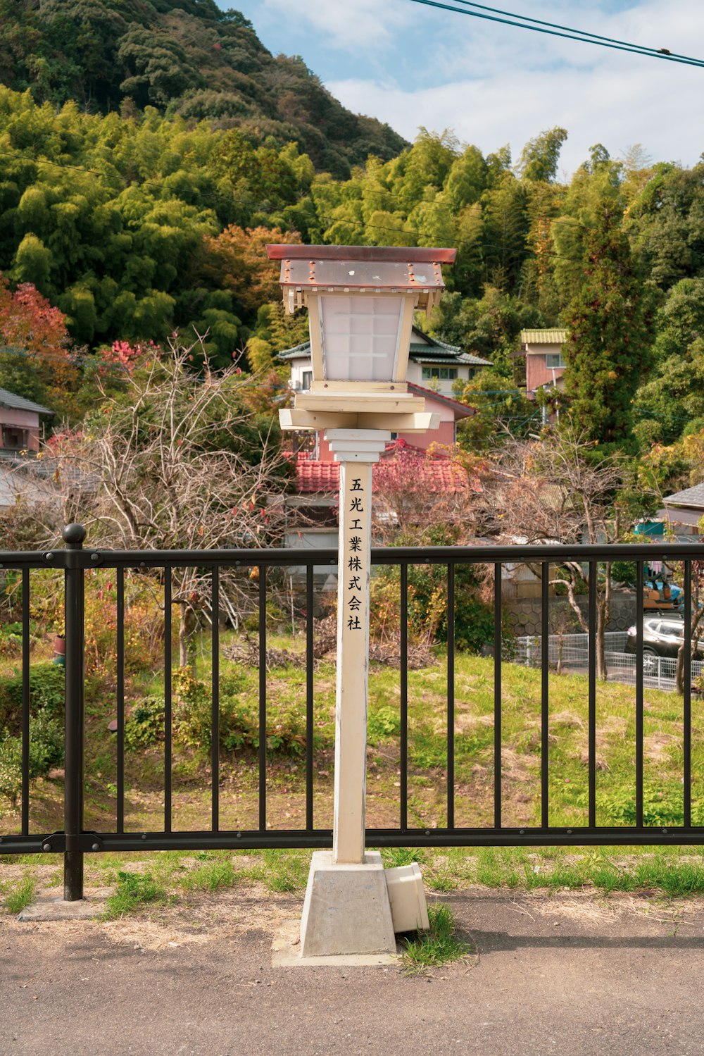 a street light sitting on the side of a road