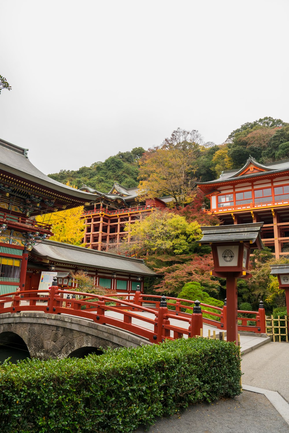 a bridge over a small pond in front of a building