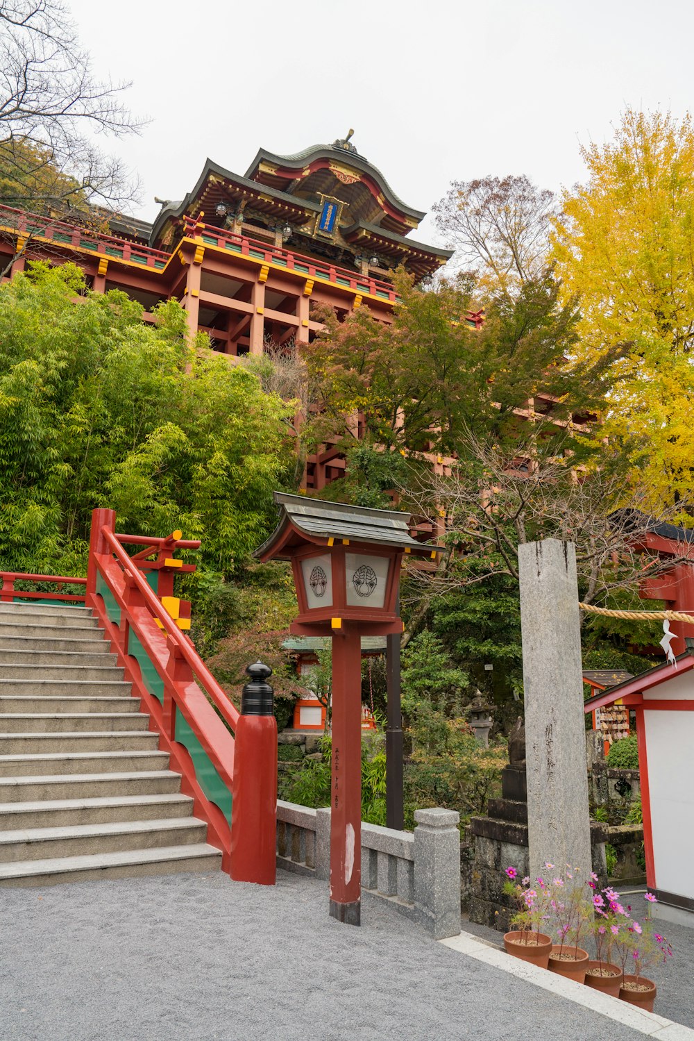 a building with a red gate and steps leading up to it