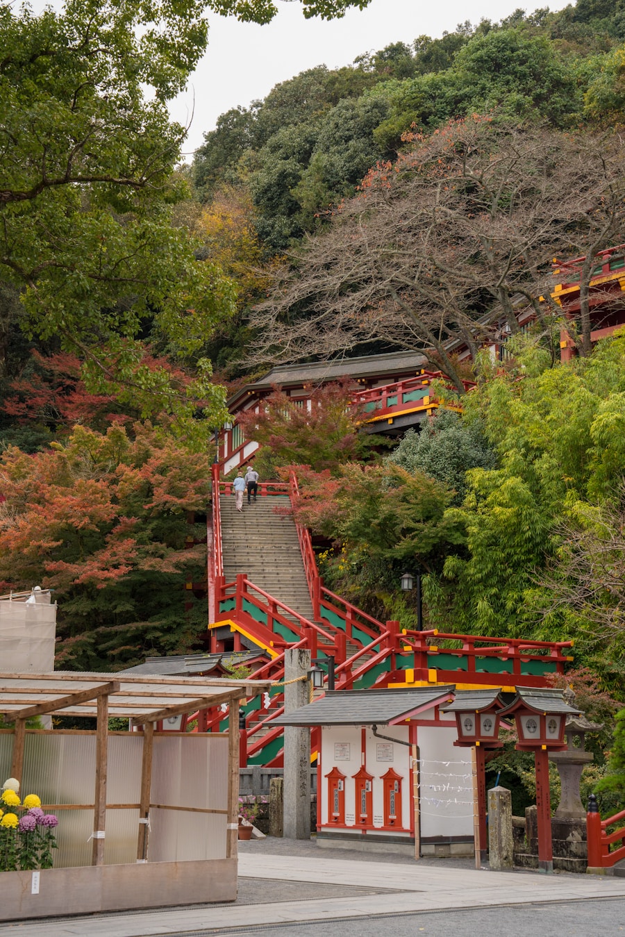 Red and gold staircase climbing the hillside at Yutoku Inari Shrine, Saga