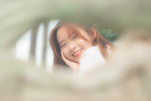 A warm, inviting photo of a person smiling gently, symbolizing self-acceptance.