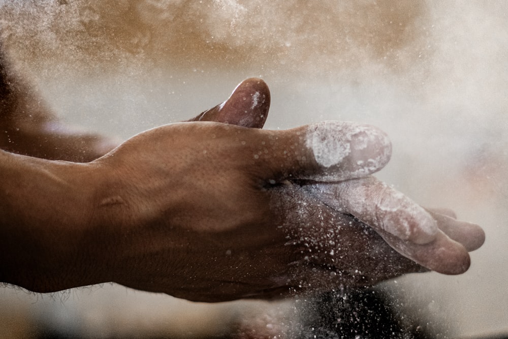 a close up of a person holding a doughnut