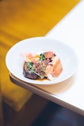 a white plate topped with food on top of a table