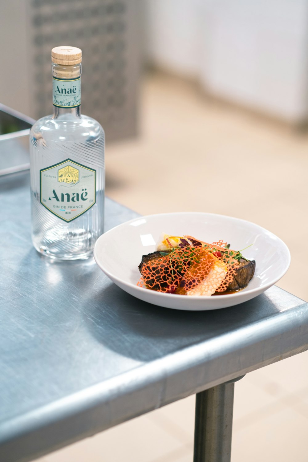 a plate of food and a bottle of water on a table