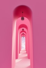 a pink tunnel with a light at the end